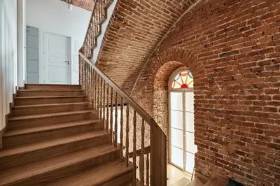 a staircase in a brick wall with a window at St Agnes Apartments Old Town in Kraków
