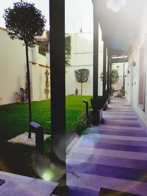 a walkway with purple lights on the side of a building at St Agnes Apartments Old Town in Kraków