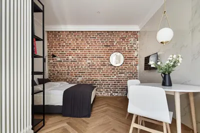 a room with a bed and a brick wall at St Agnes Apartments Old Town in Kraków