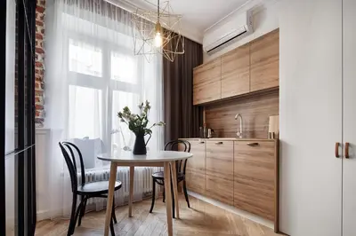 a kitchen with a table and chairs and a dining room at St Agnes Apartments Old Town in Kraków