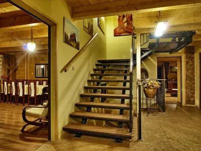 a staircase in a house with a dining room at Chata wsród Malw in Wilkowisko