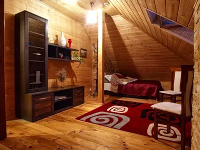 a room with a staircase and a bed and a rug at Chata wsród Malw in Wilkowisko