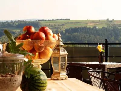 a bowl of fruit on a table with a view at Chata wsród Malw in Wilkowisko