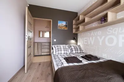 a bedroom with a bed with a sign on the wall at Stawowa Premium Apartment - 69 m2 with sauna and private garage in Kraków