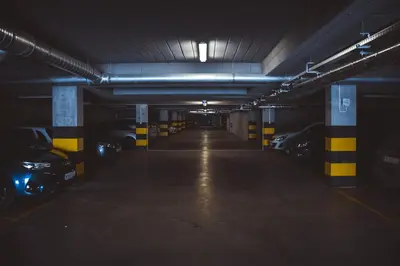 an empty parking garage with cars parked in it at Stawowa Premium Apartment - 69 m2 with sauna and private garage in Kraków