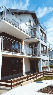 a white building with balconies on the side of it at Stawowa Premium Apartment - 69 m2 with sauna and private garage in Kraków