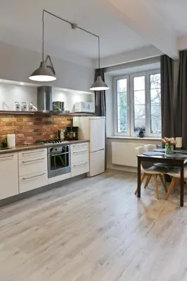 a kitchen with white appliances and a table in it at Cichy apartament w centrum Krakowa Salwator in Kraków