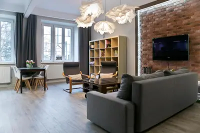 a living room with a couch and a brick wall at Cichy apartament w centrum Krakowa Salwator in Kraków
