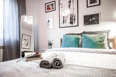 a bedroom with a bed with towels on it at LION apartments - Your own apartment in Cracow in Kraków