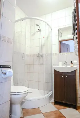 a bathroom with a tub and a toilet and a sink at LION apartments - Your own apartment in Cracow in Kraków