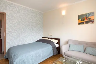 a small bedroom with a bed and a couch at Blue Sky Apartment in Kraków