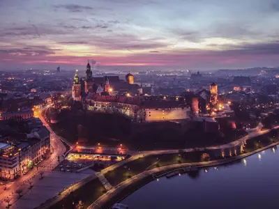 a view of a city at night with a river at Z14 Boutique Residence - Krakow Old Town in Kraków