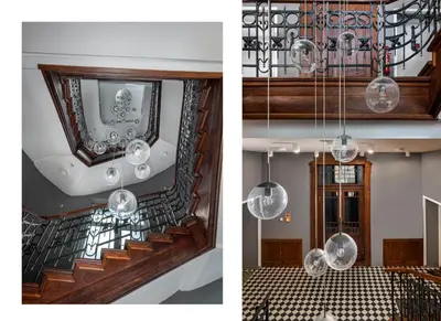 a staircase with a mirror and a chandelier at Z14 Boutique Residence - Krakow Old Town in Kraków