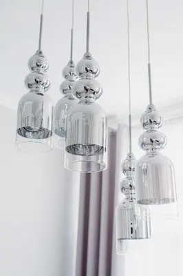 a group of glass chandeliers hanging from a ceiling at Z14 Boutique Residence - Krakow Old Town in Kraków
