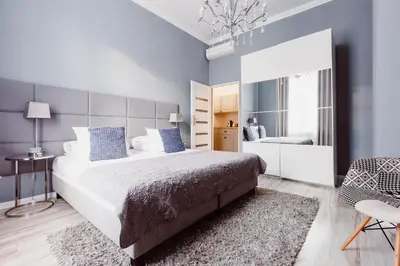 a bedroom with a large bed with blue walls at Z14 Boutique Residence - Krakow Old Town in Kraków