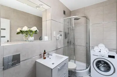 a bathroom with a washing machine and a sink at Z14 Boutique Residence - Krakow Old Town in Kraków