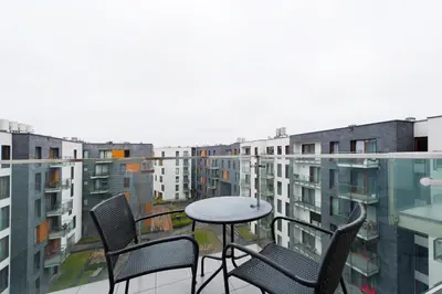 a balcony with chairs and a table on a balcony at Premium in Novum City Center, Sun & Snow in Kraków