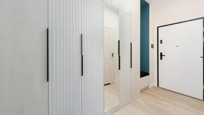 a hallway with white doors and a mirror at Premium in Novum City Center, Sun & Snow in Kraków