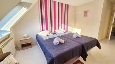 a bedroom with a bed with towels on it at VILLA CASSIA przy Parku Zdrojowym in Rabka