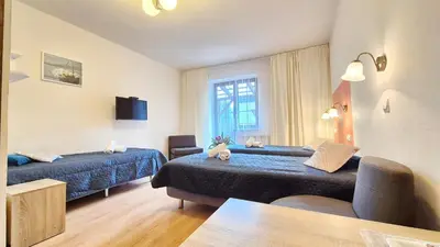 a hotel room with two beds and a table at VILLA CASSIA przy Parku Zdrojowym in Rabka