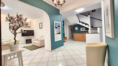 a living room with a blue and white wall at VILLA CASSIA przy Parku Zdrojowym in Rabka