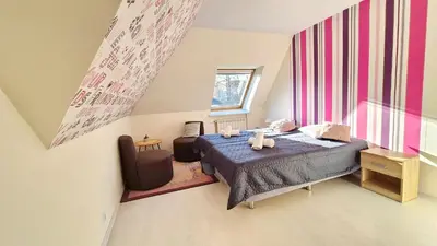 a bedroom with a bed with two stuffed animals on it at VILLA CASSIA przy Parku Zdrojowym in Rabka