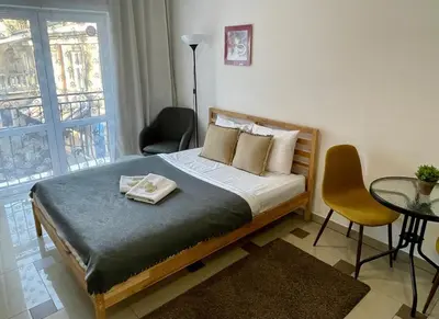 a bedroom with a bed with a table and chairs at Bubble Apartments in Kraków