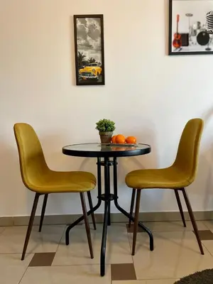 a table with two chairs and a table with oranges on it at Bubble Apartments in Kraków