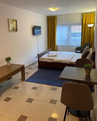 a hotel room with a bed and a table at Bubble Apartments in Kraków