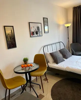 a bedroom with a bed and a table with oranges on it at Bubble Apartments in Kraków