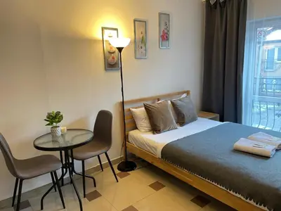 a bedroom with a bed and a table with chairs at Bubble Apartments in Kraków