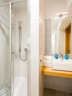 a bathroom with a shower and a sink at Riverside Aparthotel Cracow in Kraków