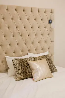 a bed with a padded headboard and pillows on it at Elegant City Center Zyblikiewicza 14 in Kraków