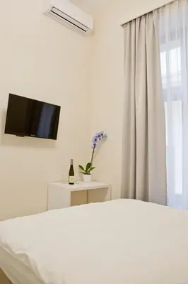 a bedroom with a bed and a flat screen tv at Elegant City Center Zyblikiewicza 14 in Kraków