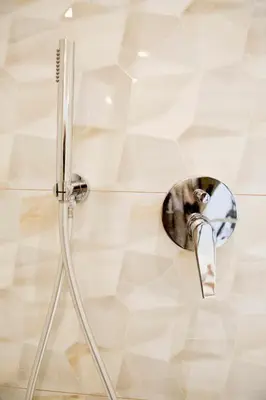 a shower in a bathroom with a shower head at Elegant City Center Zyblikiewicza 14 in Kraków