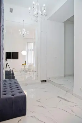 a large white room with a couch and a table at Elegant City Center Zyblikiewicza 14 in Kraków