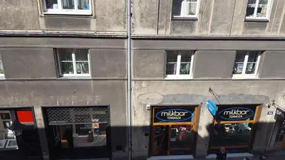 a building with two signs on the front of it at Apartment Katamaran in Kraków