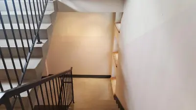 a hallway with stairs and a stair case at Apartment Katamaran in Kraków
