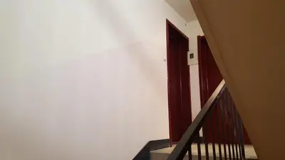 a stairway with a red door and a stair case at Apartment Katamaran in Kraków