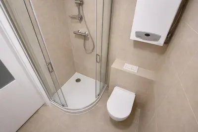 a small bathroom with a shower and a toilet at Apartment Katamaran in Kraków