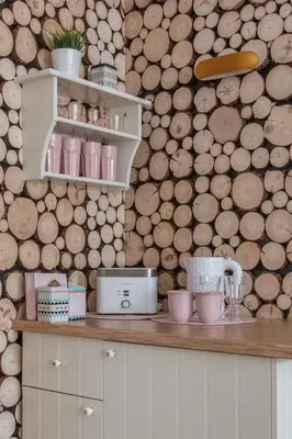 a bedroom with a bed and a wall of logs at Delis Apartments - Dluga Street 11/3 in Kraków