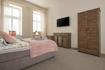 a kitchen with a wall covered in logs at Delis Apartments - Dluga Street 11/3 in Kraków
