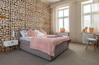 a bedroom with a bed and a flat screen tv at Delis Apartments - Dluga Street 11/3 in Kraków