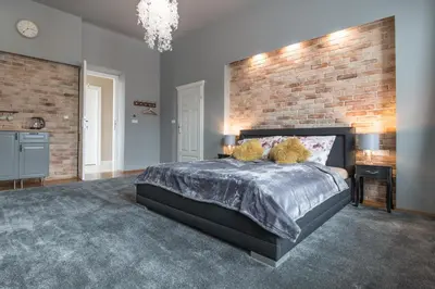 a bedroom with a bed with two pillows on it at Delis Apartments - Dluga Street 11/3 in Kraków