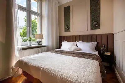 a bedroom with a large bed and a window at Between Old Town and Kazimierz in Kraków