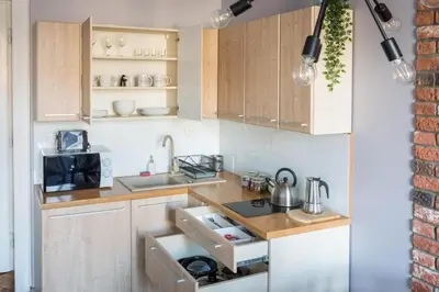 a kitchen with a sink and a stove top oven at Between Old Town and Kazimierz in Kraków
