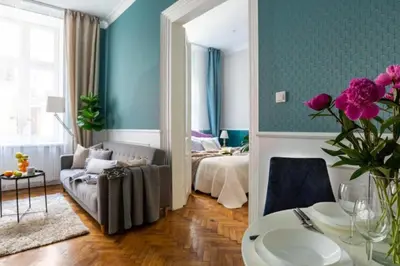 a room with a bed and a couch and a table at Between Old Town and Kazimierz in Kraków