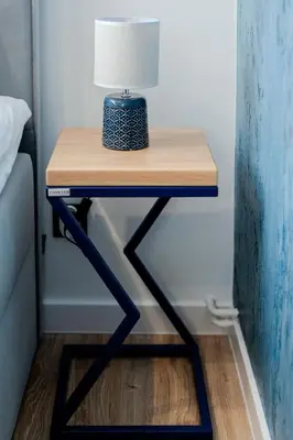 a table with a lamp on top of it at Downtown Apartments Cracow in Kraków