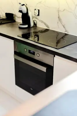 a kitchen with a stove and a counter top at Downtown Apartments Cracow in Kraków