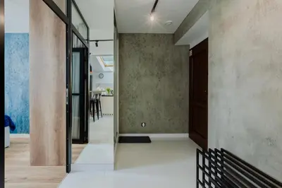 a hallway of a house with a glass door at Downtown Apartments Cracow in Kraków